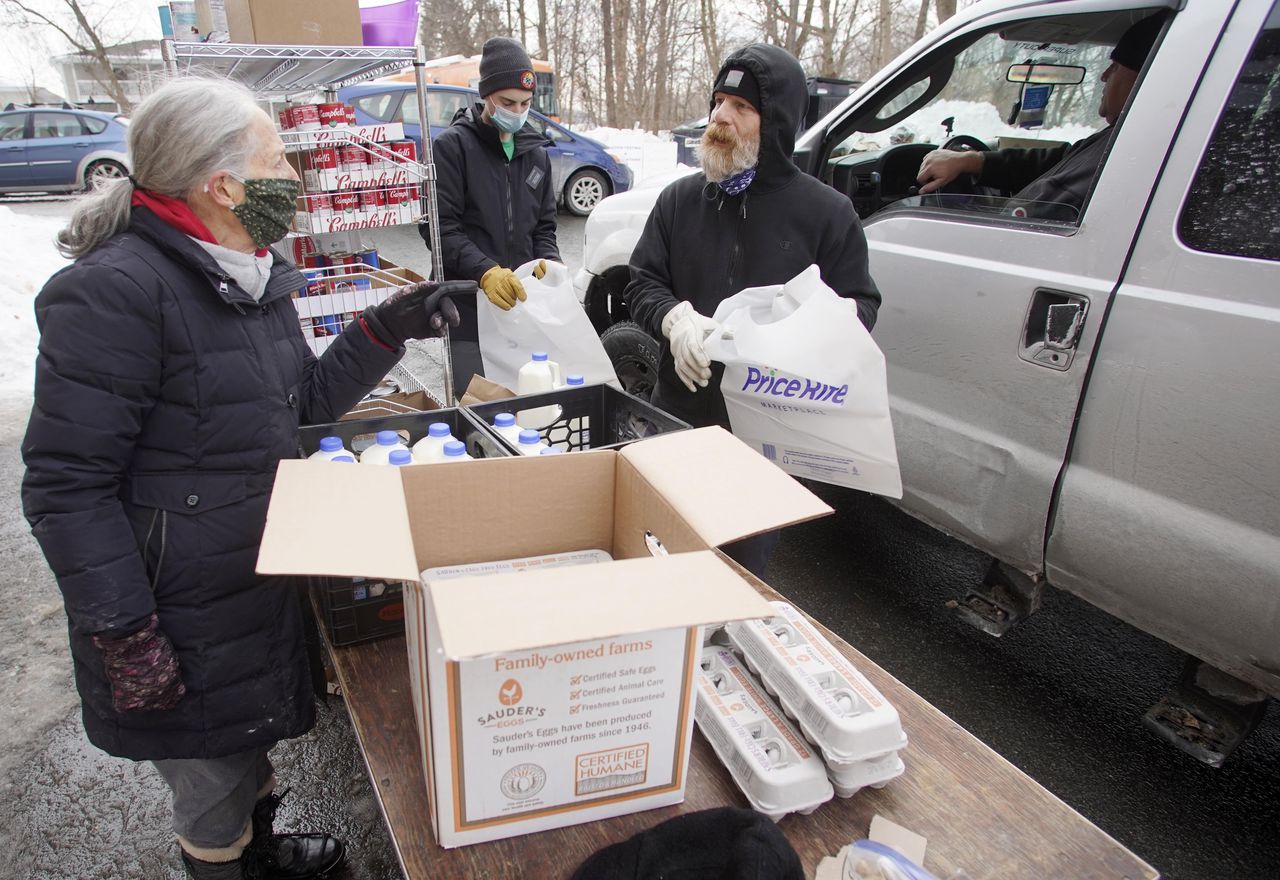 A team works to pack orders for curb-side distribution at the South Community Food Pantry in Pittsfield, Mass this January. It serves about 600 families per week.BEN GARVER/ASSOCIATED PRESS